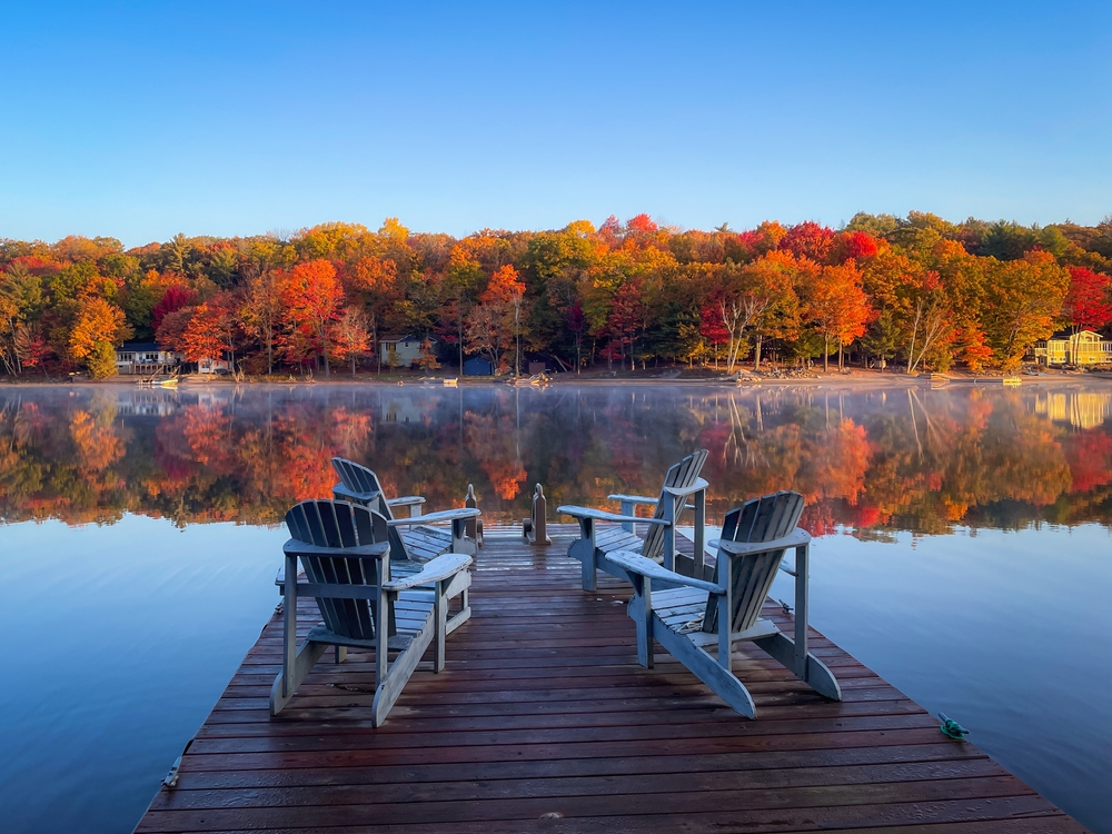 Adirondack chairs on a lakefront dock in Haliburton